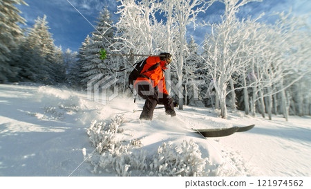 Freeride in fresh powder snow during sunny day. 121974562