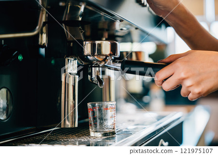 Espresso machine in cafe brewing coffee. Fresh espresso pouring into glasses demonstrating modern coffee making technology. Flowing liquid steam smooth service in coffee shop. Espresso machine in cafe brewing coffee. Fresh espresso pouring into glasses demonstrating modern coffee making technology. Flowing liquid steam smooth service in coffee shop. 121975107
