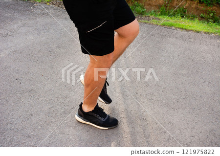 Man running up weathered concrete steps outside a building. 121975822