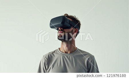 Man experiences virtual reality in a minimalist setting during daytime 121976180