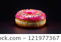 Delicious pink frosted donut with colorful sprinkles on a dark background 121977367