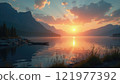 Sunset reflecting over a tranquil lake surrounded by mountains and trees 121977392