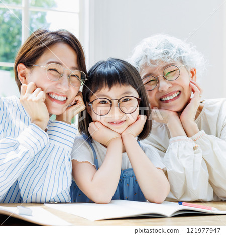 A smiling three-generation family who studies happily A smiling three-generation family who studies happily 121977947