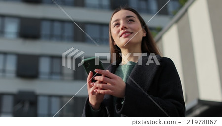 Young beautiful woman smiling confident using smartphone at street. Smartphone browsing internet, searching, reading news in social media. Young beautiful woman smiling confident using smartphone at street. Smartphone browsing internet, searching, reading news in social media. 121978067