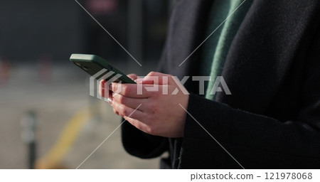 Woman hands using smartphone outdoors on city. Searching or social networks concept. Woman hands using smartphone outdoors on city. Searching or social networks concept. 121978068
