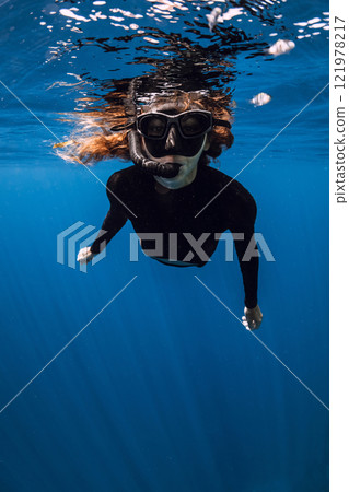 Female freediver with diving mask swimming in tropical blue ocean Female freediver with diving mask swimming in tropical blue ocean 121978217