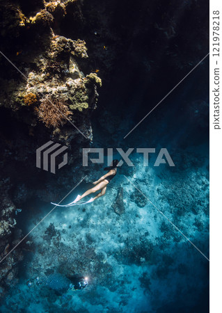 Woman freediver underwater on deep ocean near coral reef in Menjangan, Bali. 121978218