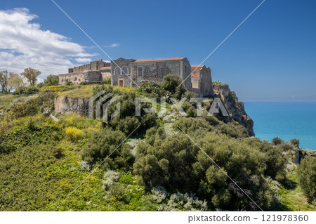 Green hill with the Milazzo Castle, Sicily, Italy 121978360