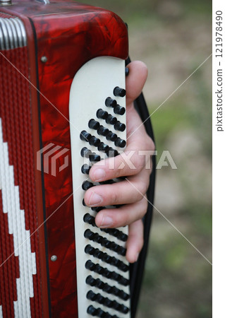 Fingers Moving Fast On The Buttons Of The Accordion  121978490