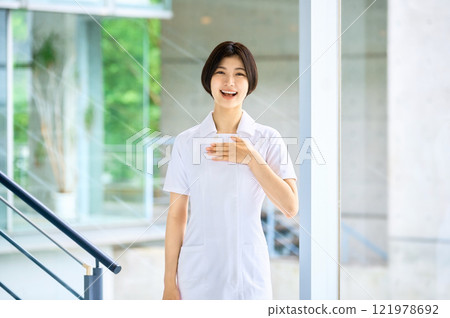Smiling medical worker in white coat working in hospital Smiling medical worker in white coat working in hospital 121978692