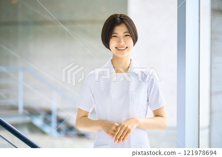 Smiling medical worker in white coat working in hospital Smiling medical worker in white coat working in hospital 121978694