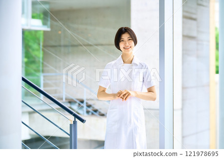Smiling medical worker in white coat working in hospital Smiling medical worker in white coat working in hospital 121978695