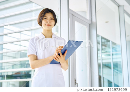 Smiling medical worker in white coat working in hospital Smiling medical worker in white coat working in hospital 121978699