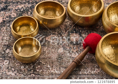 Brass Singing Bowls on Rug 121978895