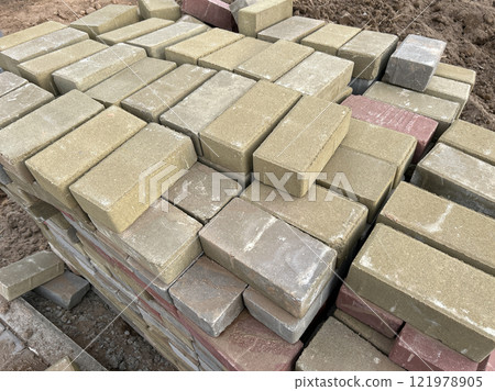 The cobblestones are stacked in neat piles The cobblestones are stacked in neat piles 121978905