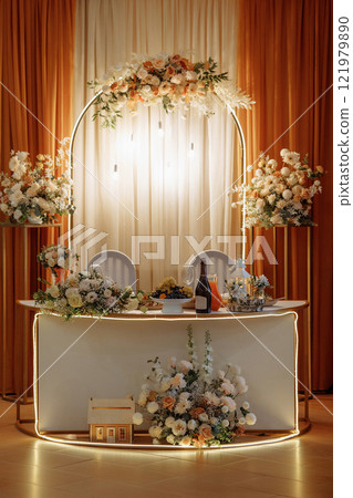 A table decorated with white flowers for a wedding celebration. Banquet decorator services. 121979890