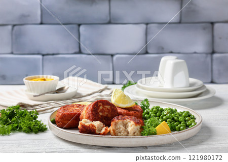 Danish atlantic cod fish cakes with green peas 121980172