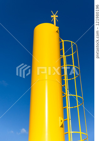 Yellow navigation tower with cross shaped top mark 121980196