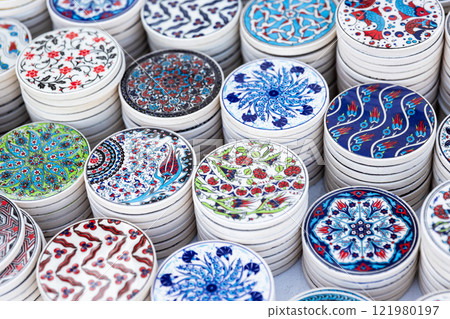 White ceramic coasters with oriental patterns are on a counter White ceramic coasters with oriental patterns are on a counter 121980197