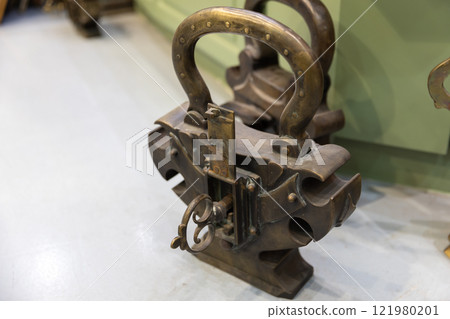 Ancient padlock with a key inside 121980201
