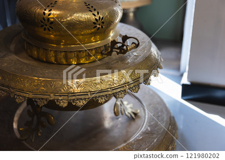 An ancient incense burner is in antique shop 121980202