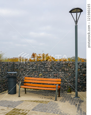 New modern seaside environmental object with gabion wall, bench, trash can and LED lighting 121980285