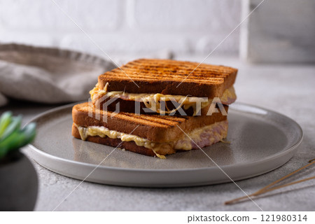 Grilled sandwich with ham and melted cheese Grilled sandwich with ham and melted cheese 121980314
