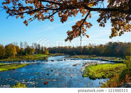 Colorful, picturesque autumn view of the largest European waterfall on the Venta River in Latvia Colorful, picturesque autumn view of the largest European waterfall on the Venta River in Latvia 121980315