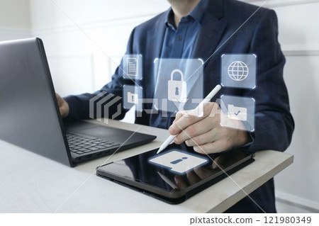 Man in suit working on laptop, digital tablet. Cyber security shield, lock. Glowing icons of computer alerts, folders. Protection of sensitive data, digital environment against hacker attacks threats. 121980349