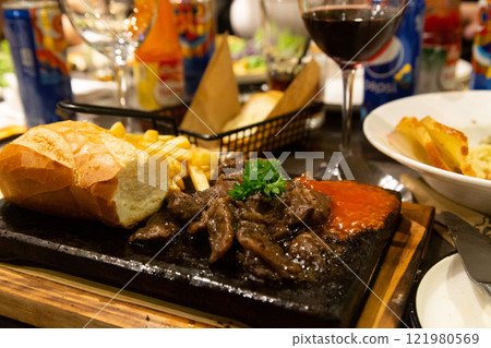 Elegant Restaurant with Steak, Bread, and Wine Perfect Setting for a Party and Fine Dining Experience. High quality photo Elegant Restaurant with Steak, Bread, and Wine Perfect Setting for a Party and Fine Dining Experience. High quality photo 121980569