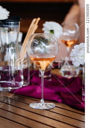 Elegant rose wine glass centerpiece with vibrant decor, perfect for celebrations and fine dining 121980809