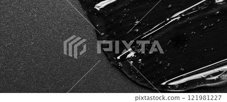 Transparent cosmetic moisturizing gel or skin serum on a black background. Copy space 121981227