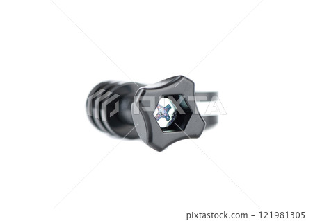 Metal screw screwed into black plastic fastener on white background. Metal screw screwed into black plastic fastener on white background. 121981305
