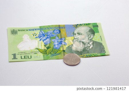 One leu banknote and ten bani coin Romania money closeup. 121981417
