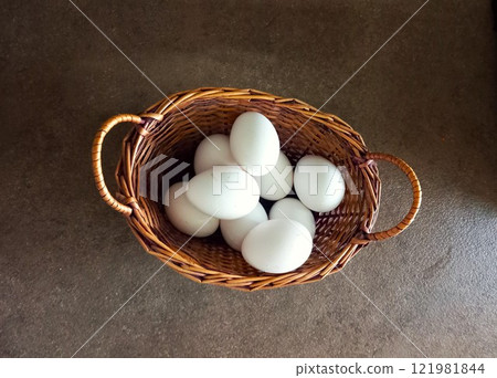 chicken eggs in a basket on a black background 121981844