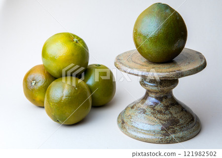 Navel Chocolate Orange on the cake stand. White background. Navel Chocolate Orange on the cake stand. White background. 121982502