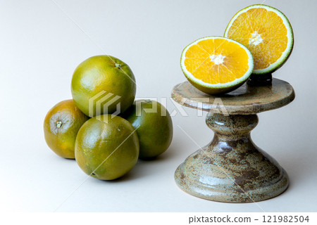 Navel Chocolate Orange on the cake stand. White background. 121982504