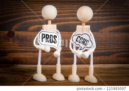 Pros and Cons. Two speech bubbles and miniature people on a wooden texture background 121983097