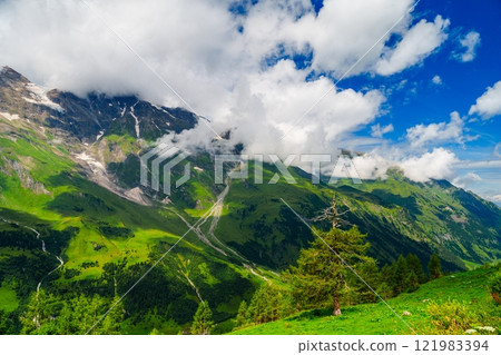 Picturesque Mountain Landscape with Lush Green Hills and Clouds in Kaprun, Austria 121983394