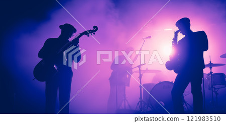 Jazz Band silhouette unrecognizable on stage. Violet background, smoke, concert spotlights 121983510