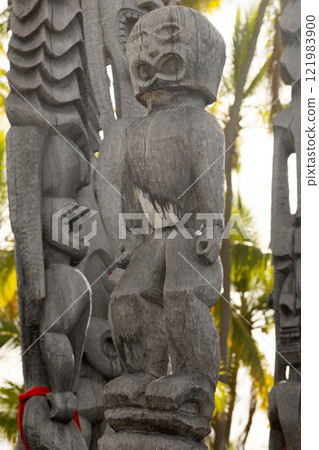 Wooden statue of Hawaiian god in the national historical park. 121983900