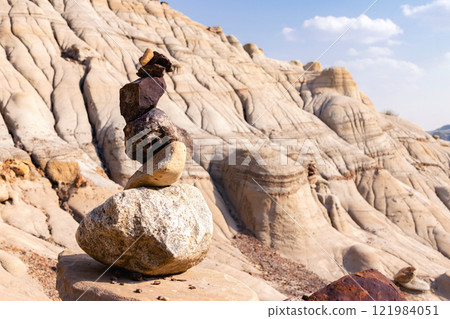 Stack of bright balancing rocks in badland canyon in summer. Stack of bright balancing rocks in badland canyon in summer. 121984051