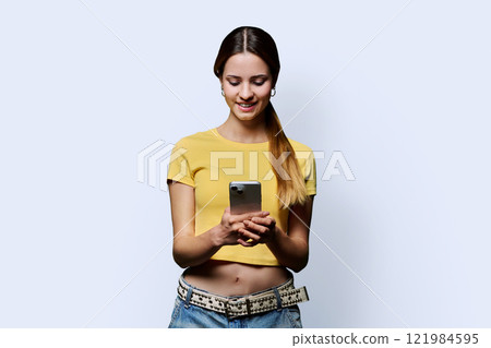Young beautiful woman using smartphone on white studio background 121984595