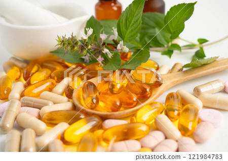 Alternative medicine herbal organic capsule with vitamin E omega 3 fish oil, mineral, drug with herbs leaf natural supplements for healthy good life. Alternative medicine herbal organic capsule with vitamin E omega 3 fish oil, mineral, drug with herbs leaf natural supplements for healthy good life. 121984783