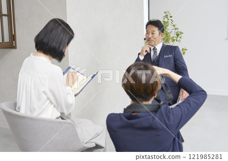 Female reporter interviewing a businessman Female reporter interviewing a businessman 121985281