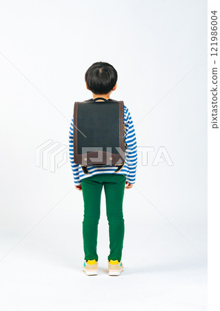 Full-body photo of a boy in elementary school carrying a backpack 121986004