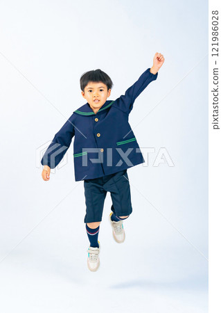 Full-body photo of a boy in children's clothing jumping 121986028