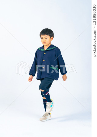 Full-body photo of a boy walking in children's clothes Full-body photo of a boy walking in children's clothes 121986030