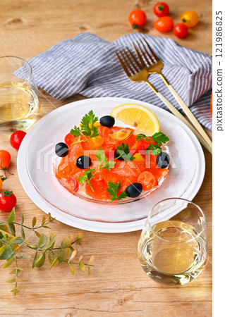 Salmon carpaccio, carpaccio salad, salmon and cherry tomato carpaccio, Italian 121986825