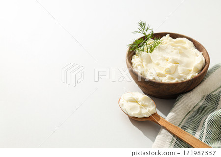 Philadelphia cheese in a wooden plate, on a white background. 121987337